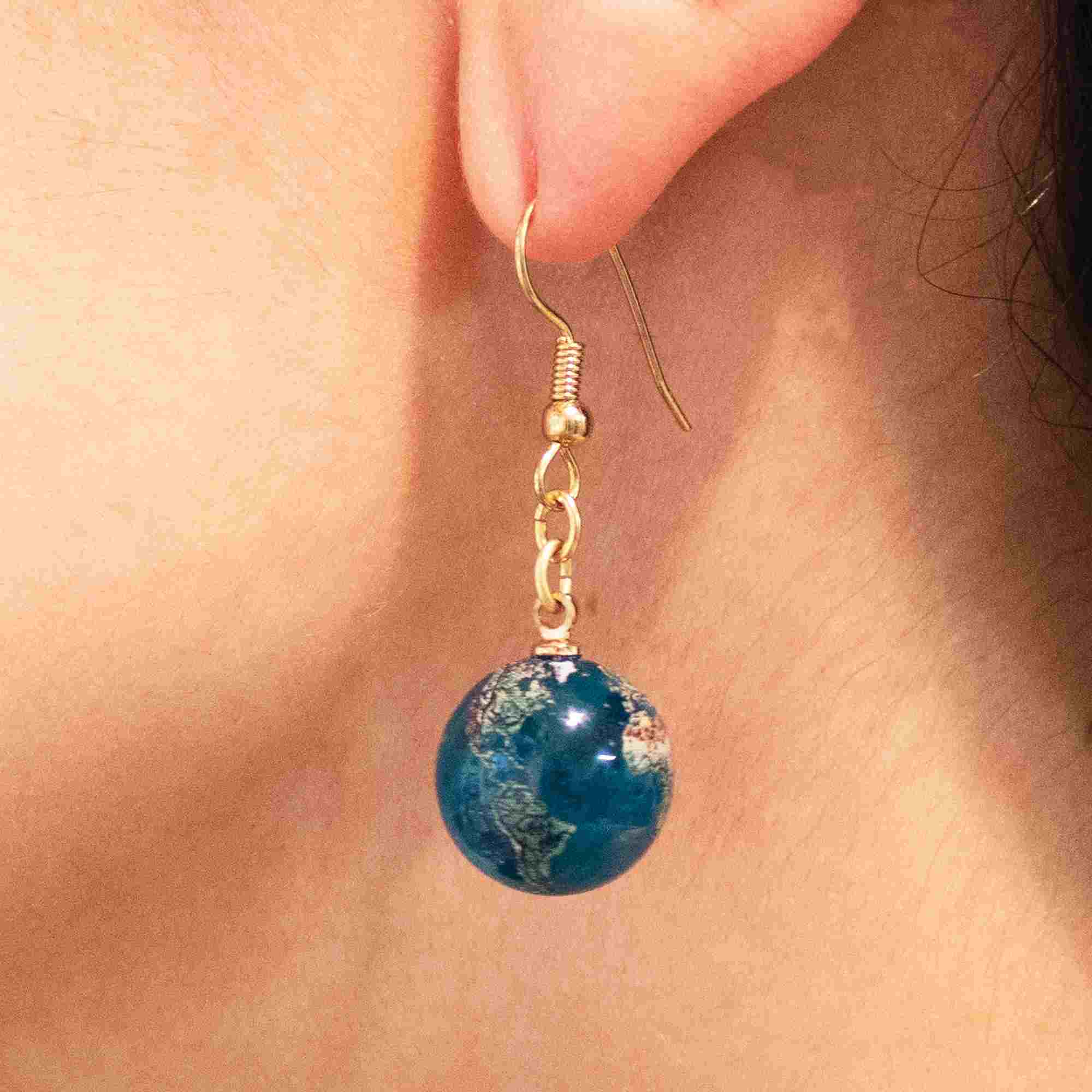 Natural earth earrings woman side view