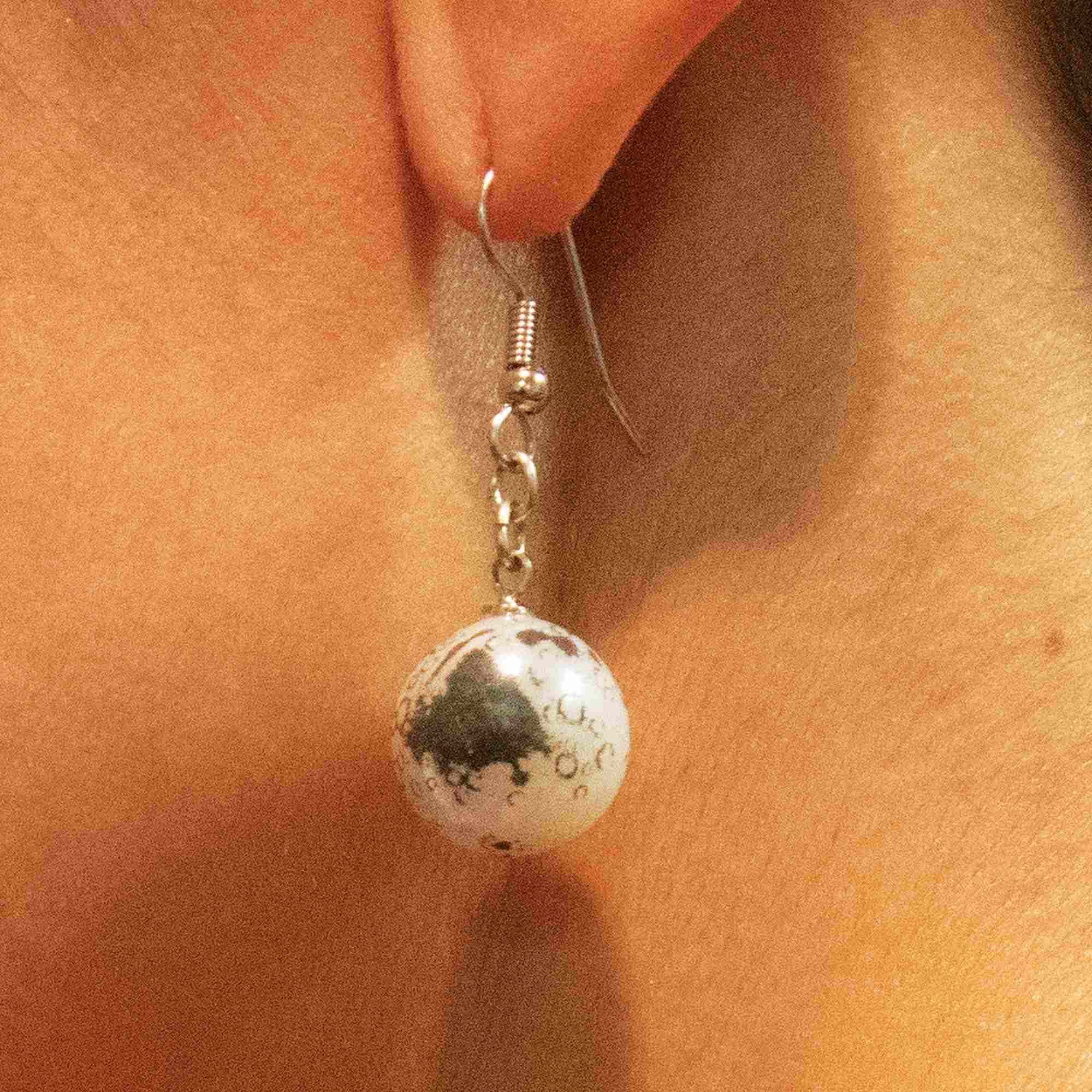 moon earrings on woman facing side