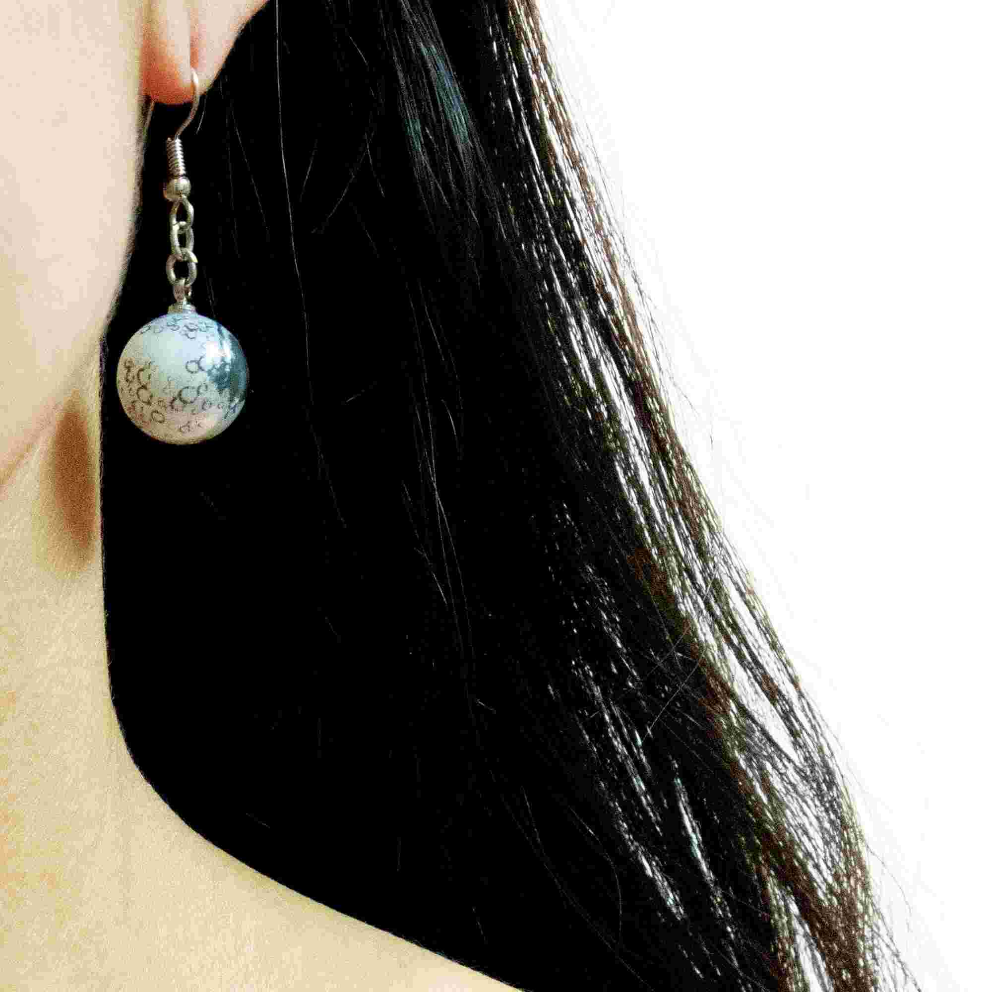 moon earrings on woman facing forward